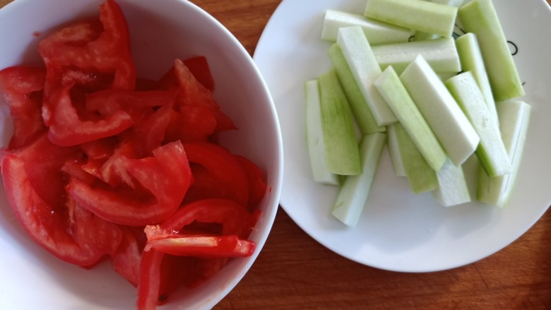 番茄炒丝瓜,将两个都切好装盘子备用，以免一会儿炒菜的时候手忙脚乱。