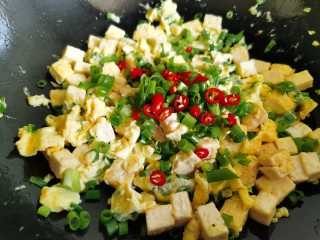 豆腐炒鸡蛋,把辣椒和剩下的一半葱花加入。