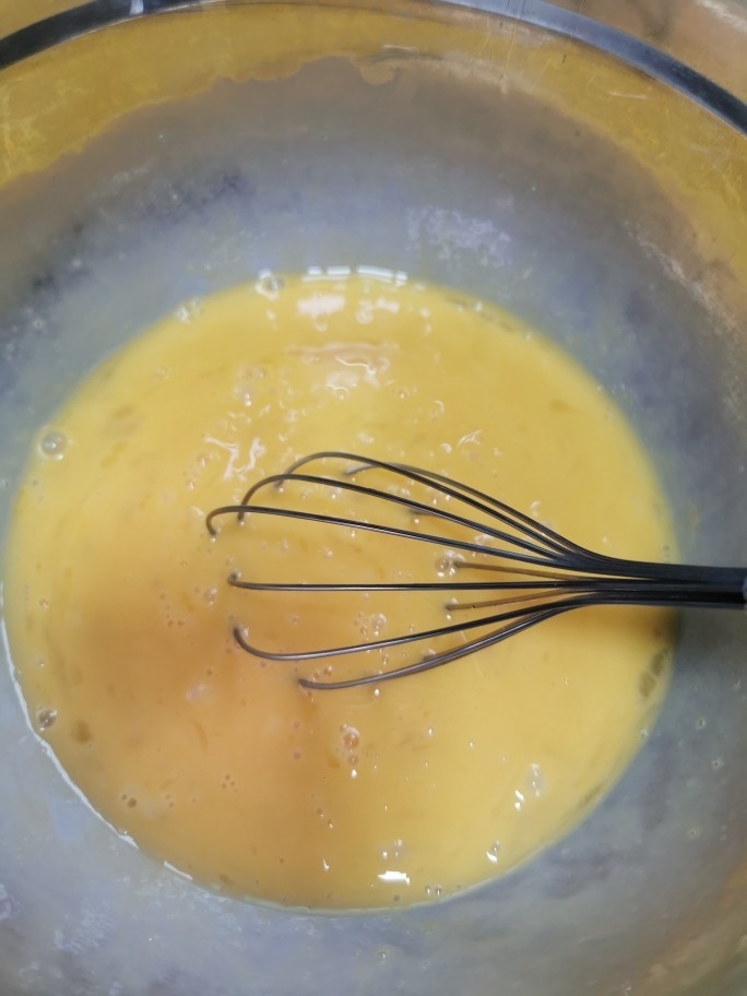 榴莲千层蛋糕,鸡蛋全部打入一个干燥大碗里，用手动打蛋器打散，不要太过用力，打出大气泡泡就不美观了