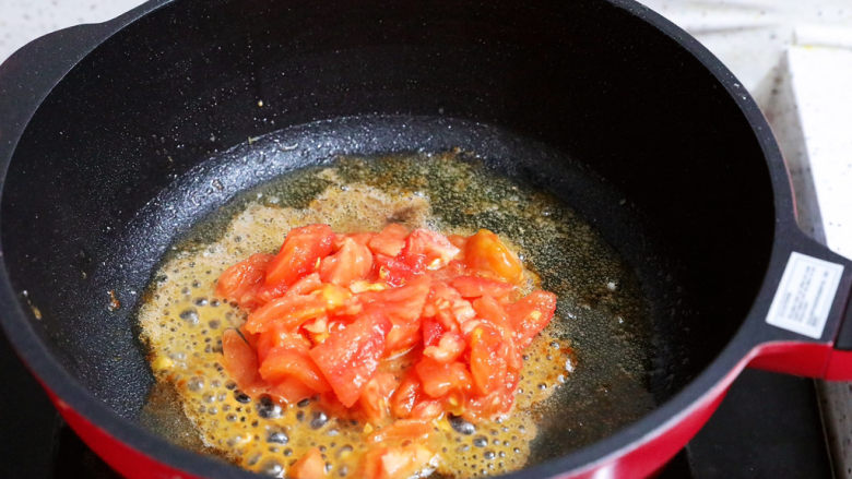 番茄虾仁培根蛋炒饭,锅中倒入适量的食用油烧热，放入番茄翻炒至出汁