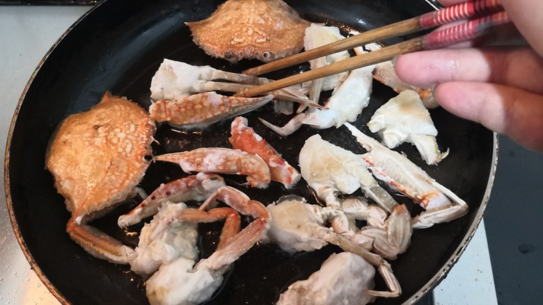 香辣螃蟹,把螃蟹的两面，煎至通红