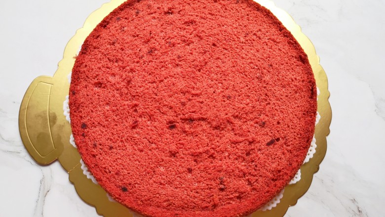 红丝绒水果裸蛋糕,蛋糕板上铺一张花边油纸，放上一片蛋糕。