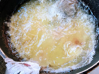 炸鱼块,锅中倒入适量油加热至六成热放入鱼骨炸起来