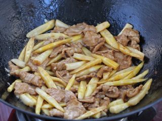 蚝油箭笋小炒肉,最后把炒好的肉片倒回锅中，改大火混合翻炒均匀即可。