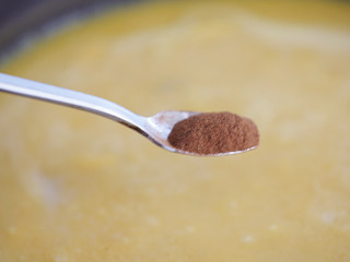 奶油南瓜汤,加入肉桂粉慢慢拌均匀，肉桂粉不太好溶解，多拌一会就好了，装盘撒上葵花子装饰趁热饮用。
