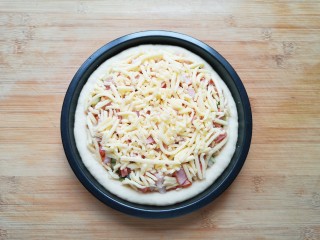 培根火腿披萨,最后再撒上一层马苏里拉芝士，以同样的方法做好另一个披萨。