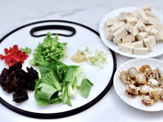 海鲜木耳豆腐羹,用刀切碎小米辣和葱姜，小油菜洗净切段，香菜摘洗干净切段。