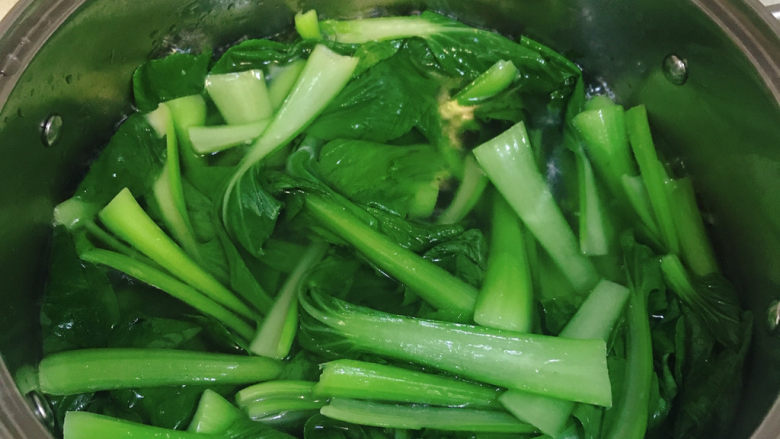 香菇炒青菜,水开加几滴食用油，一勺盐，下青菜焯两分钟，颜色变的翠绿，捞出备用。