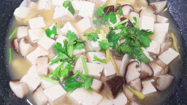 香菇炖豆腐,下入香菜碎搅拌均匀。