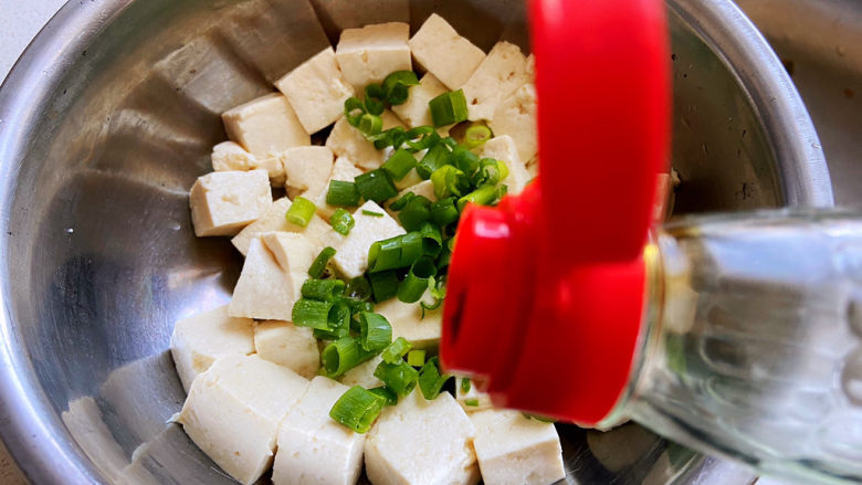 小葱拌豆腐,<a style='color:red;display:inline-block;' href='/shicai/ 692'>酱油</a>加一点，拌匀，让每块豆腐都沾上。