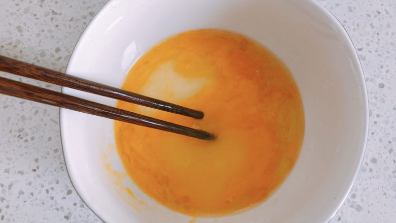 豆腐鸡蛋羹,用筷子搅拌。