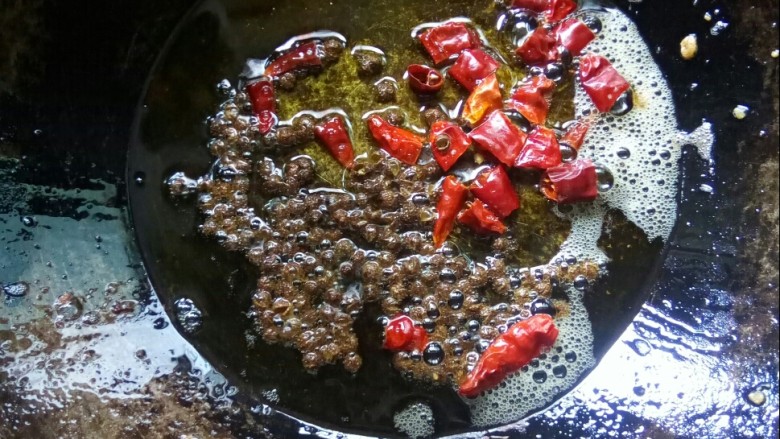 酸豆角炒肉末,炒锅留底油，放干辣椒粒和花椒小火炒香。