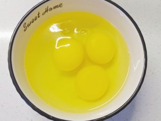 酸豆角炒鸡蛋,碗中打入三个鸡蛋