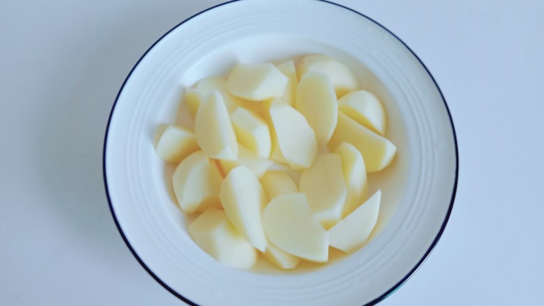 新疆大盘鸡,土豆与胡萝卜分别削皮切成滚刀块。