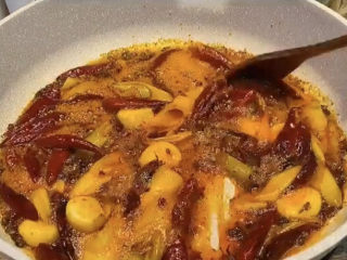 麻辣虾尾,彻底的翻炒均匀，要炒出红油的那种，这样才能激出香味，而且后面虾尾上色也靠这一步了。