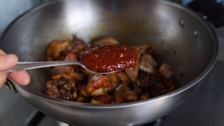 新疆大盘鸡,加入辣豆瓣酱翻炒均匀。