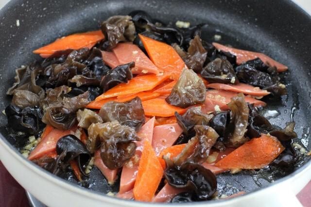 红烧日本豆腐,接着放入胡萝卜和黑木耳，改大火快速翻炒至木耳噼啪作响。