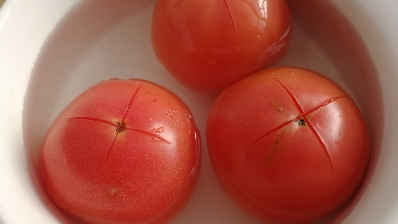 西红柿鸡蛋拌面,西红柿顶部切十字花刀，开水里烫2分钟。