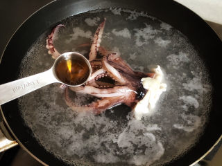 干贝海鲜粥,放入鱿鱼头，加五克料酒去腥增香，煮至变色，捞出