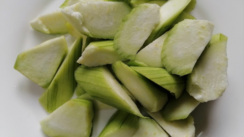 丝瓜炖豆腐,将丝瓜滚刀切切成块状