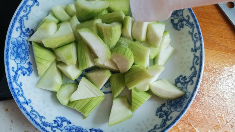 丝瓜炖豆腐,装入盘中加入适量的盐拌均匀腌制10分钟