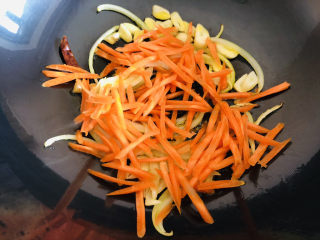 爆炒绿豆芽,放入胡萝卜丝翻炒几下，豆芽比胡萝卜容易熟所以先放胡萝卜丝。