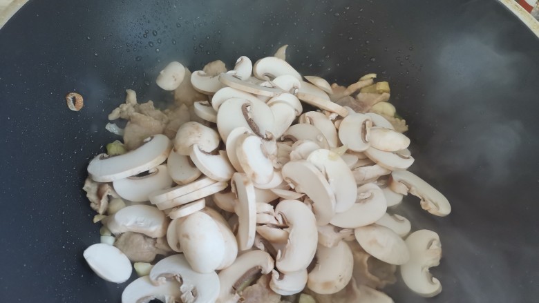 蘑菇炒肉,下入蘑菇翻炒