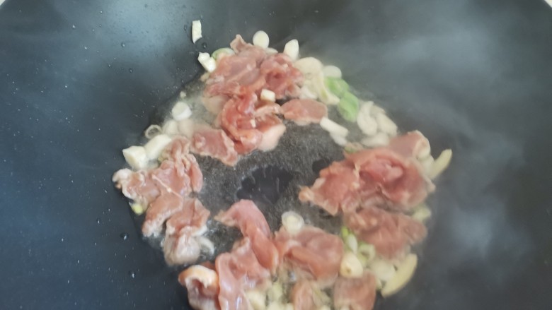 蘑菇炒肉,下入肉片翻炒至变色