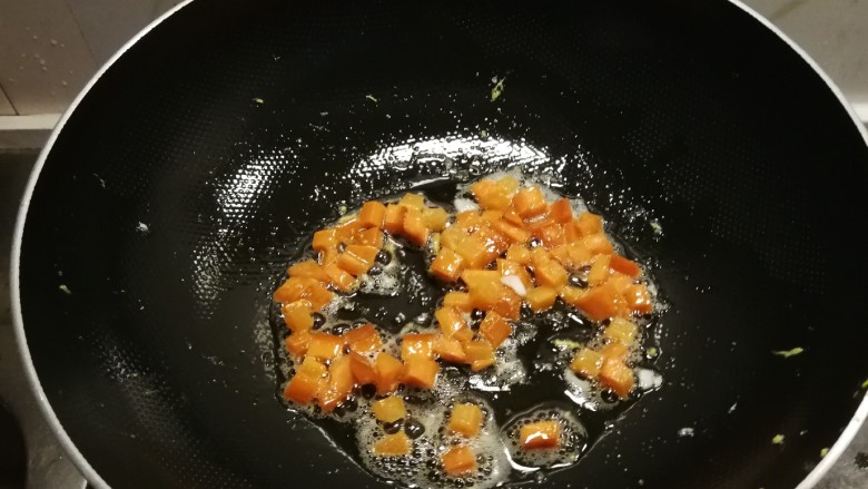 橄榄菜炒饭,再起油锅，用锅中底油继续加热，放入胡萝卜丁翻炒。
