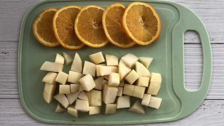 秋梨香橙花果茶,把橙子切成片，梨子去皮去核，切成小块。