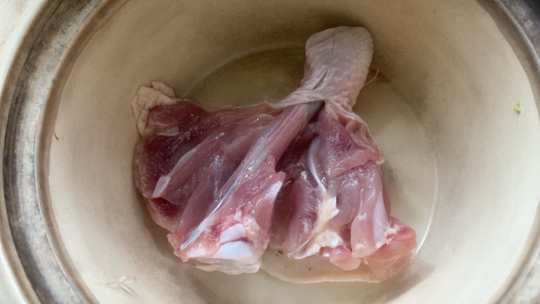 鸡腿炖蘑菇,然后将砂锅加热，鸡皮一侧入锅中慢慢煎出鸡油。
