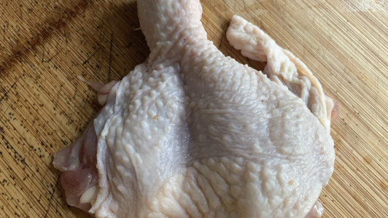 鸡腿炖蘑菇,一只大鸡腿切上一刀，使得鸡肉呈现铺平更好成熟的状态。