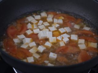 番茄豆腐汤,放入切成小块的豆腐继续煮一会