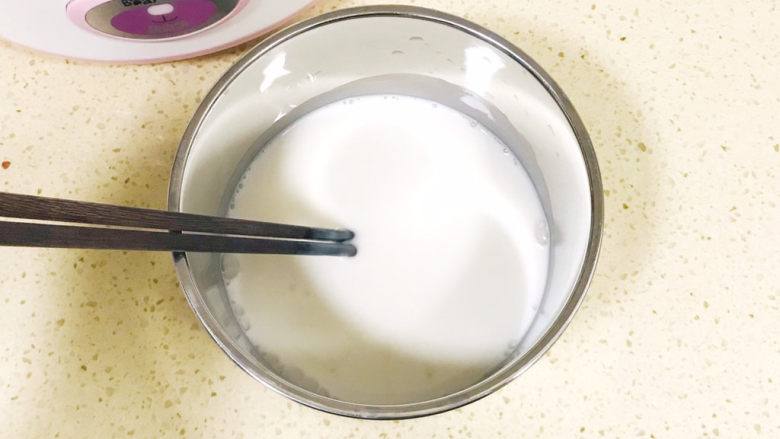 手工酸奶,用筷子不停地搅拌，使鲜牛奶与发酵乳充分融合起来