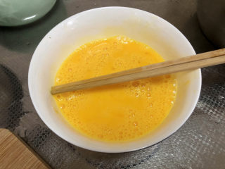芹菜叶炒鸡蛋,土鸡蛋打入碗中，搅打成蛋液