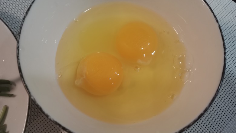 炒合菜,碗中打入两个鸡蛋。