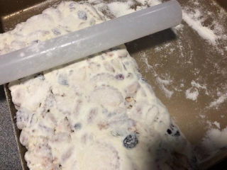 蔓越莓雪花酥,把雪花酥放在烤盘里，按压整理成型，冷却后切块即可开动。