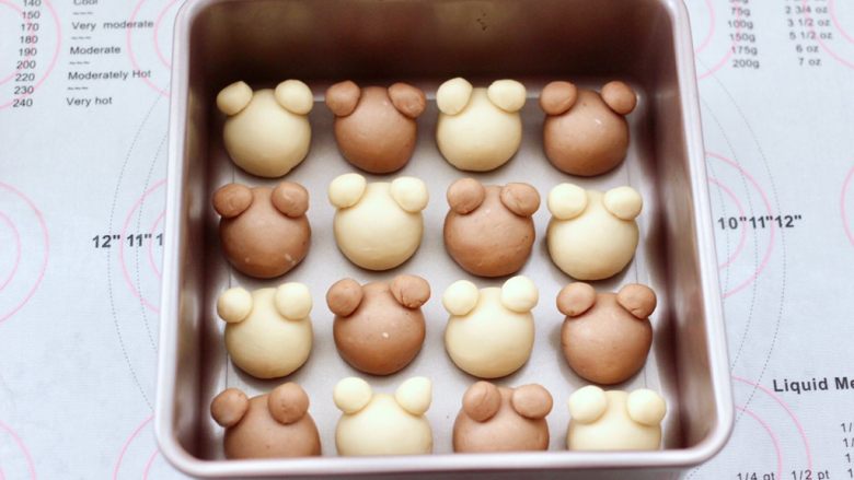 一次发酵网红小熊挤挤面包，宝贝超爱,滚圆的面团依次码放在烤盘里，小面团蘸点清水粘在耳朵的位置。