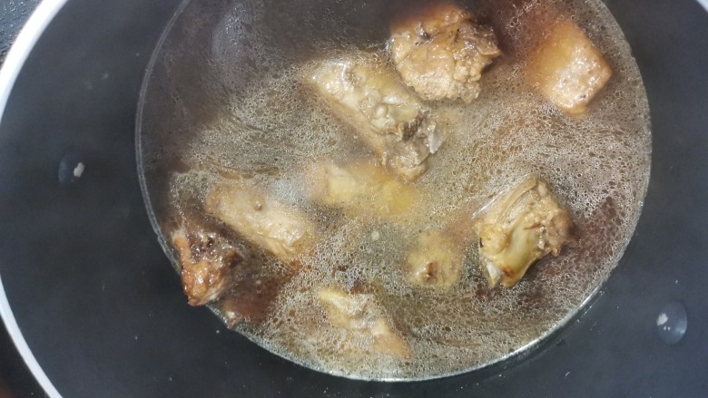排骨糯米饭,换一个汤锅继续煮，加入盐煮到排骨接近熟的状态。