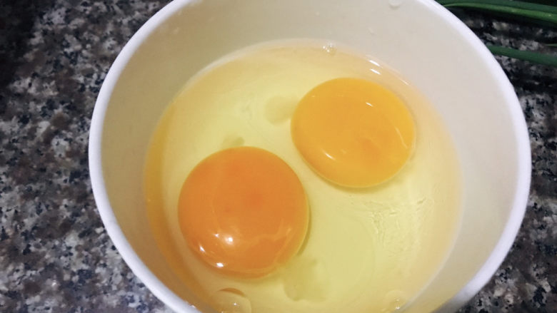 鸡蛋炒年糕,碗中打入两个鸡蛋