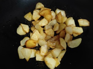 孜然土豆,再放进另一个无油无水的锅中，不用开火，将土豆倒入，再撒点孜然粉，盐，鸡精，酱油，葱花