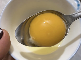 红豆双皮奶,将一个鸡蛋打入碗中，取出蛋黄。