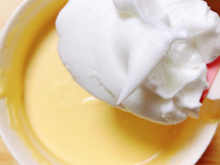 酸奶芝士蛋糕,把芝士糊从冰箱拿出来，经过冷藏的芝士糊会变得更浓稠一些。挖1/3蛋白到芝士糊里。
