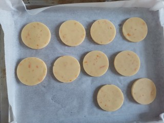 香橙🍊曲奇饼干,把面团上下铺上保鲜膜，擀成3毫米厚的薄饼放入冰箱冷冻30分钟后，取出来用圆形模具压出形状