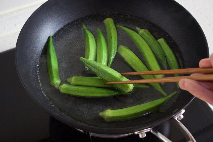 秋葵炒鸡蛋,锅中水烧开，把秋葵倒入锅中焯一下。