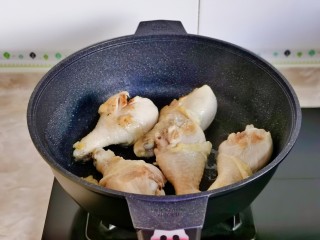 电饭锅焖鸡腿,起油锅加入鸡腿煎至表面微黄。