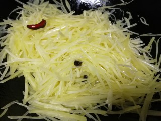 青椒炒土豆丝,油热放入土豆丝，急火翻炒均匀。