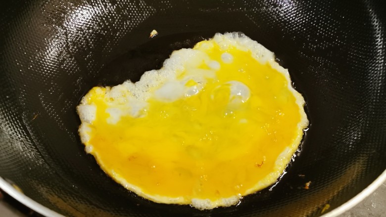 尖椒炒鸡蛋,锅中留下底油继续加热，倒入鸡蛋液。