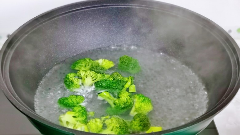 蒜蓉西兰花,锅中加水烧开，加一小勺食用盐下西兰花焯水30秒捞出，过冷水。
