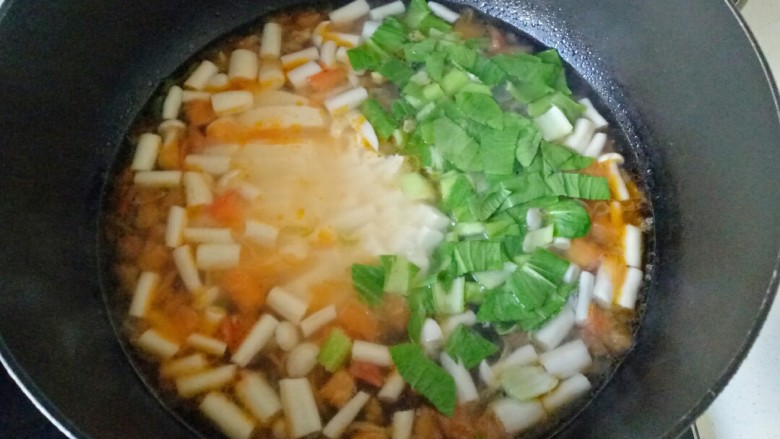 白玉菇豆腐汤,加入豆腐条和青菜碎再次煮开